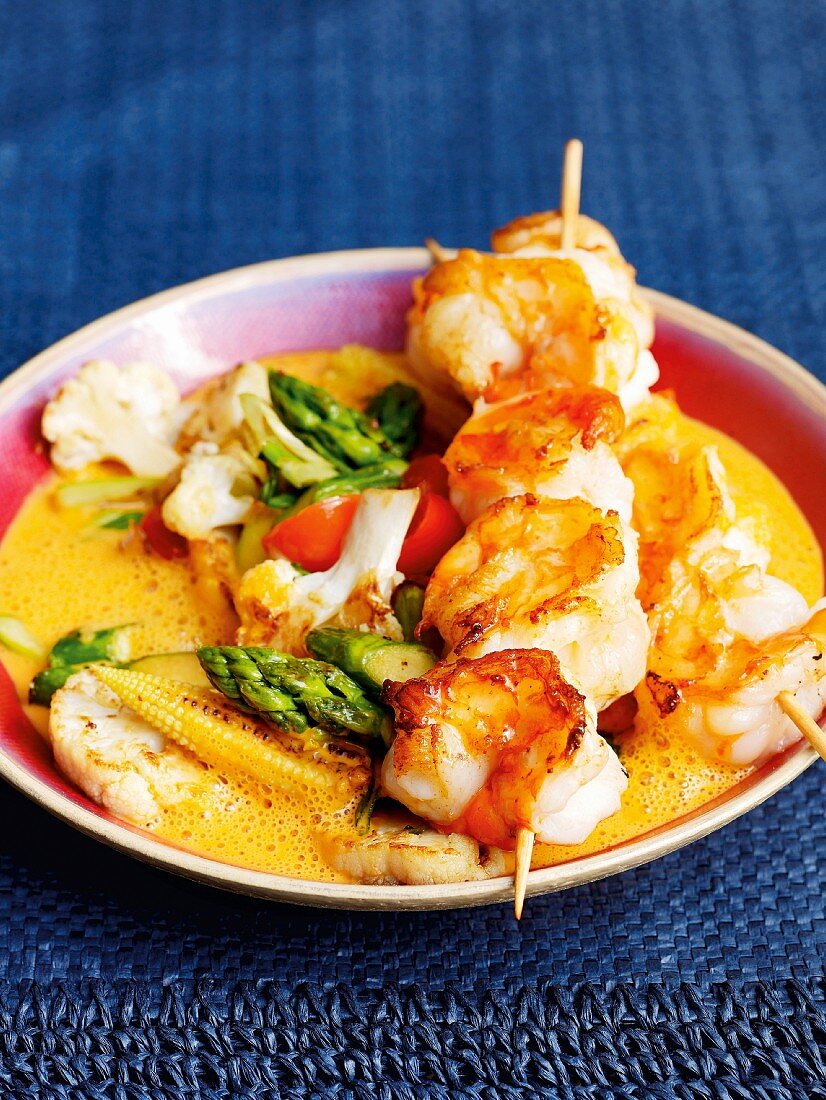 Prawn skewers with a red curry sauce