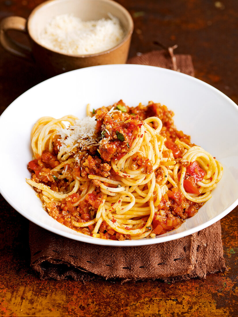 Spaghetti Bolognese with fresh basil in bowl