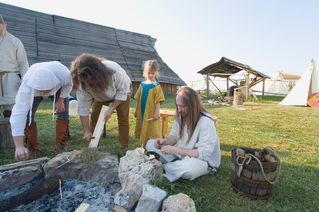 People working near fireplace in Franconian Switzerland, Bavaria, Germany