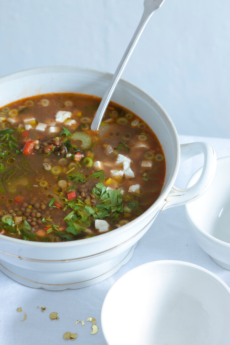 Lentil soup with harissa and feta in serving bowl