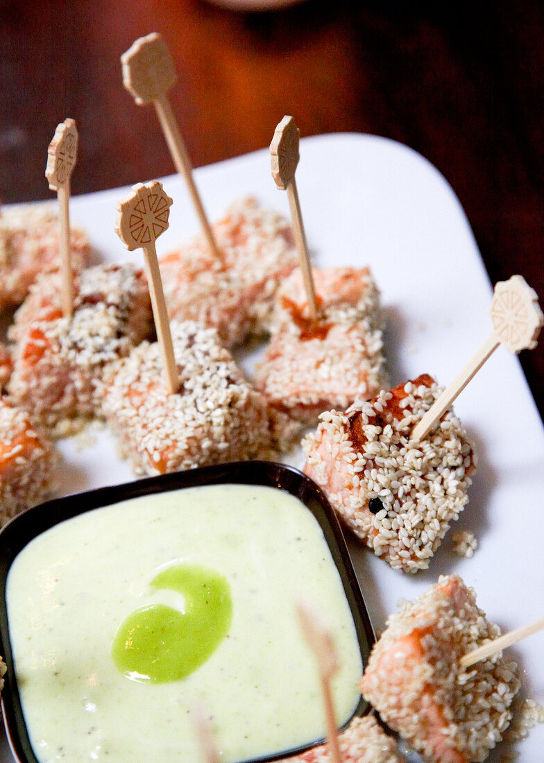 Close-up of diced salmon with sesame wasabi sour cream on plate