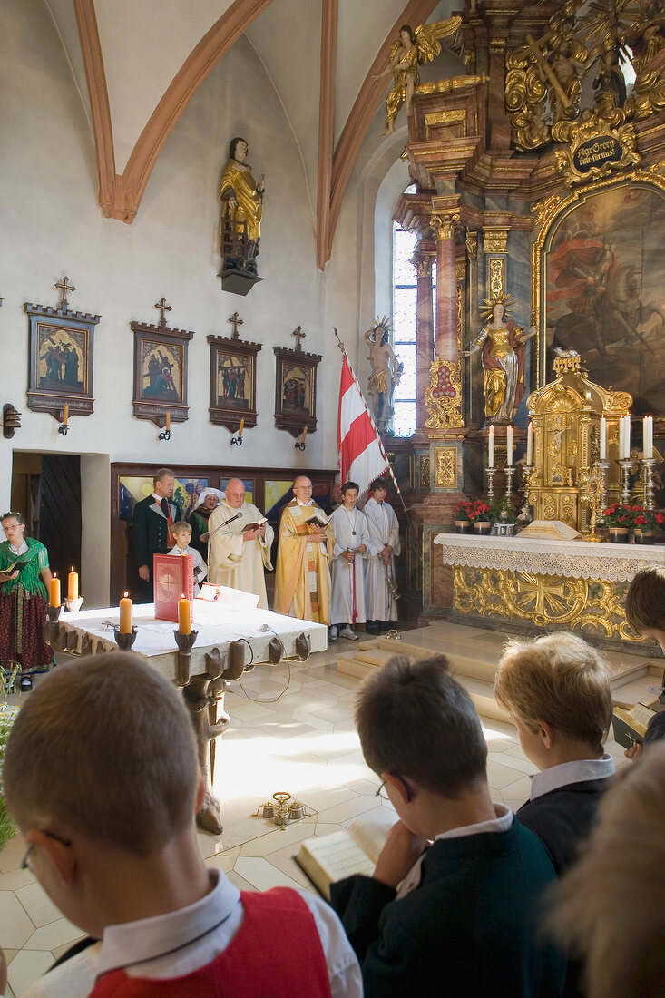 Priests praying in church in Franconian Switzerland, Bavaria, Germany