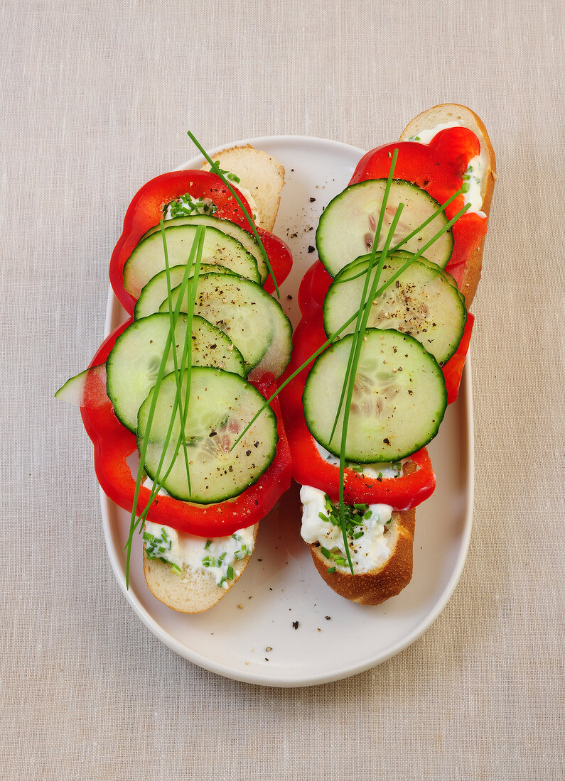 Pretzel sticks with quark, chives, cucumbers and peppers in serving dish