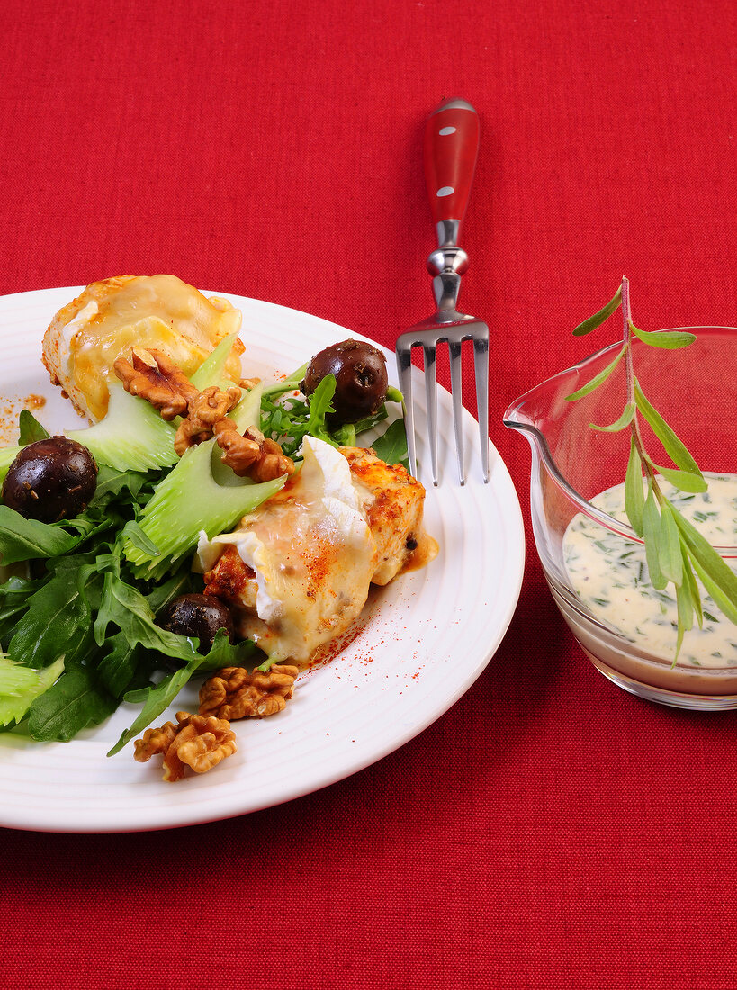 Arugula salad with gratin chicken on plate
