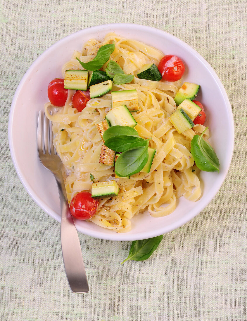 Tagliatelle with tomato and white sauce in bowl