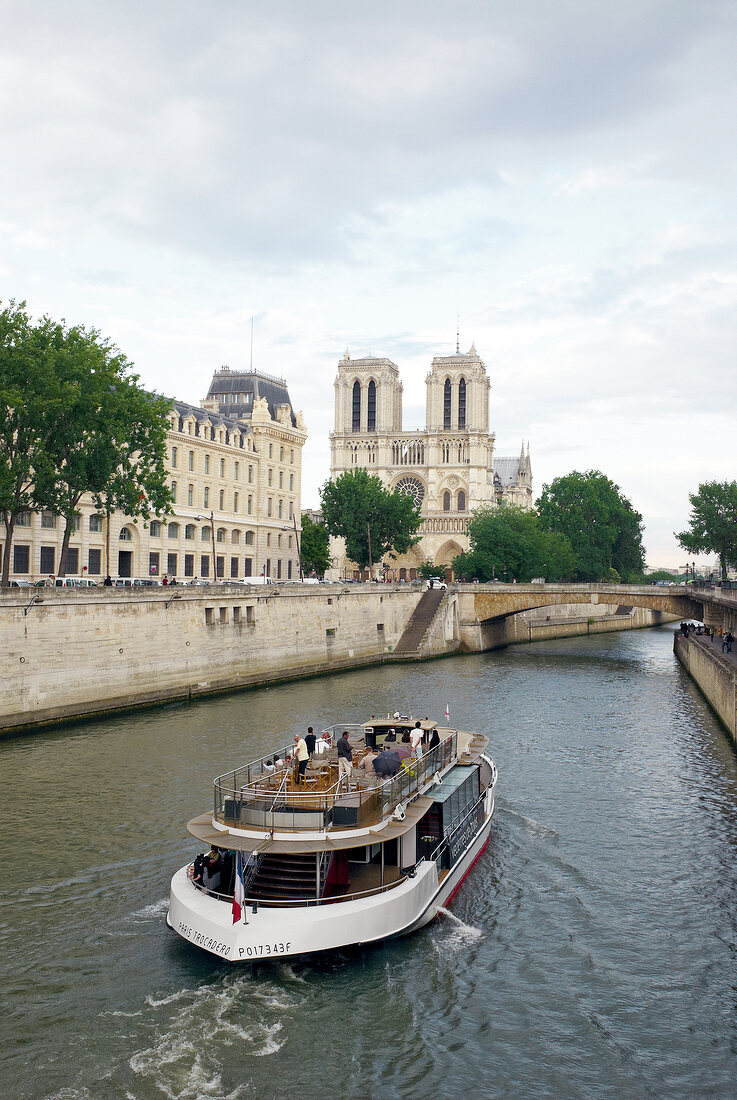 View of Notre-Dame and boat in Seine river, Paris, France
