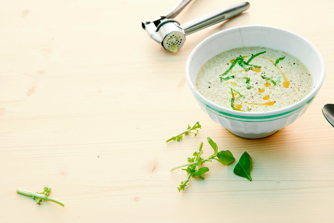 Broccoli and basil soup in bowl
