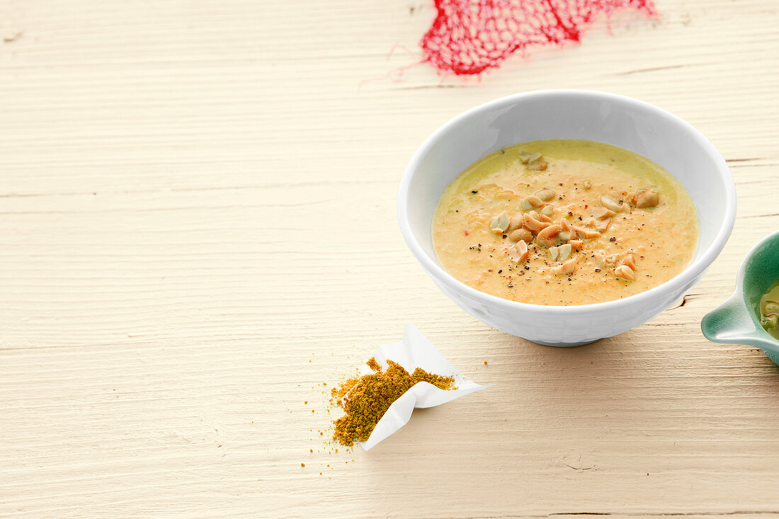 Red lentil soup with peanuts in bowl