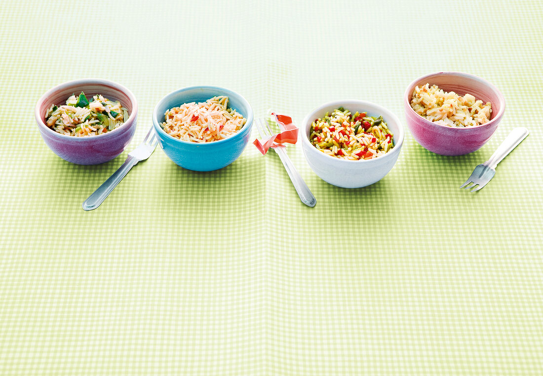 Four different rice dishes in bowls