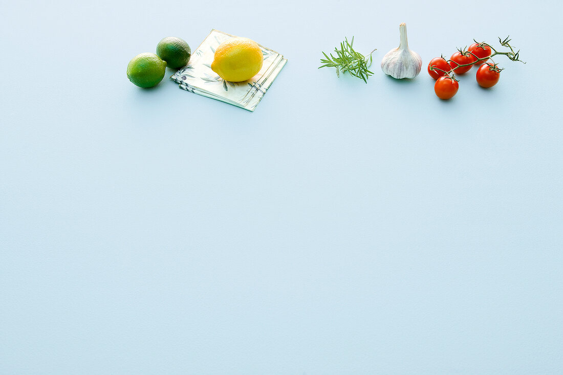 Lime, lemon, rosemary and garlic on white background