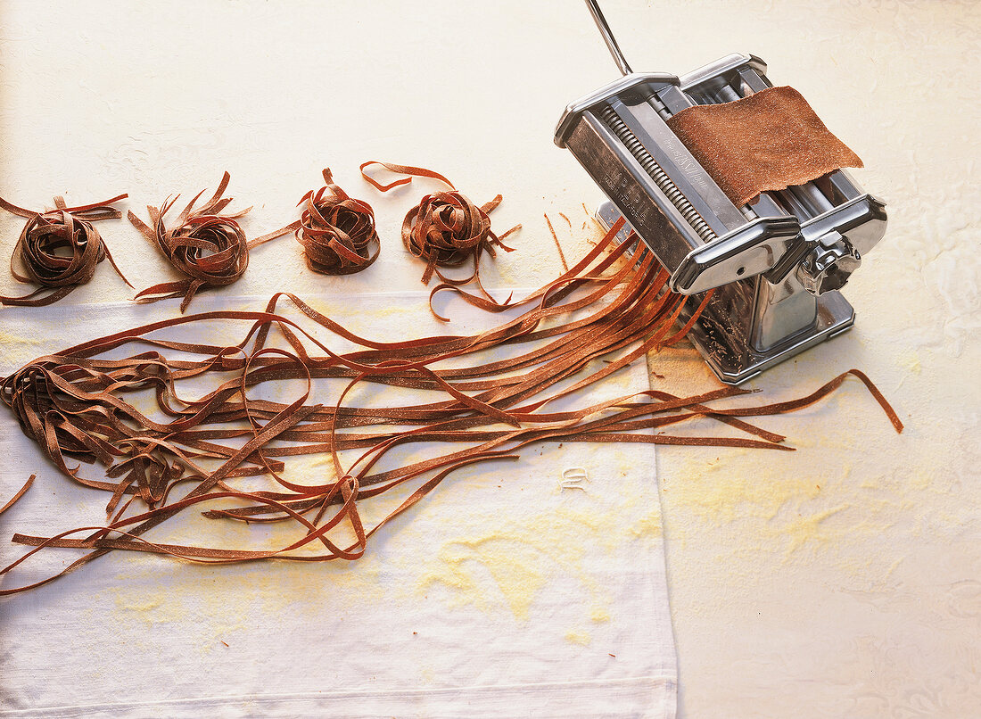 Close-up of cocoa noodles pasta with machine