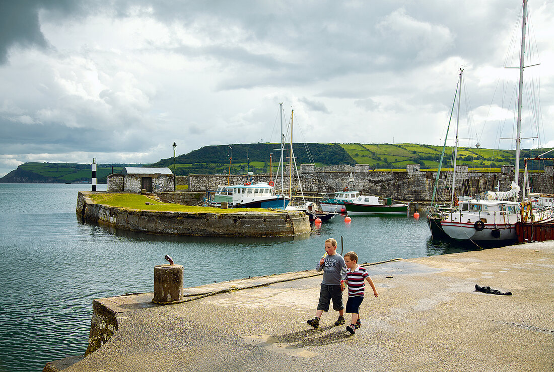 Children at dock near Carnlough Harbour with Boat, Ireland