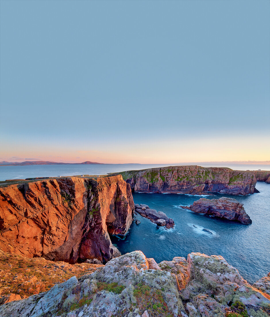View of rocky coast of Atlantic at sunset in Tory Island, Ireland