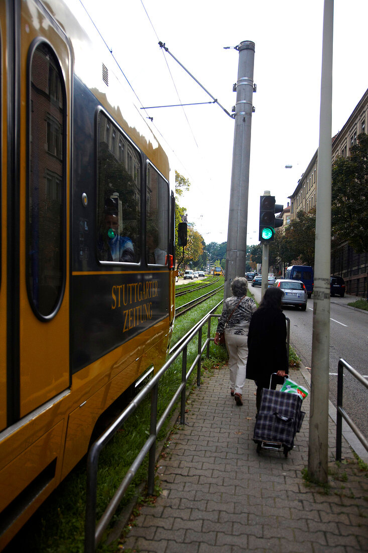 Two women walking on road beside Tramway in Stuttgart, Germany