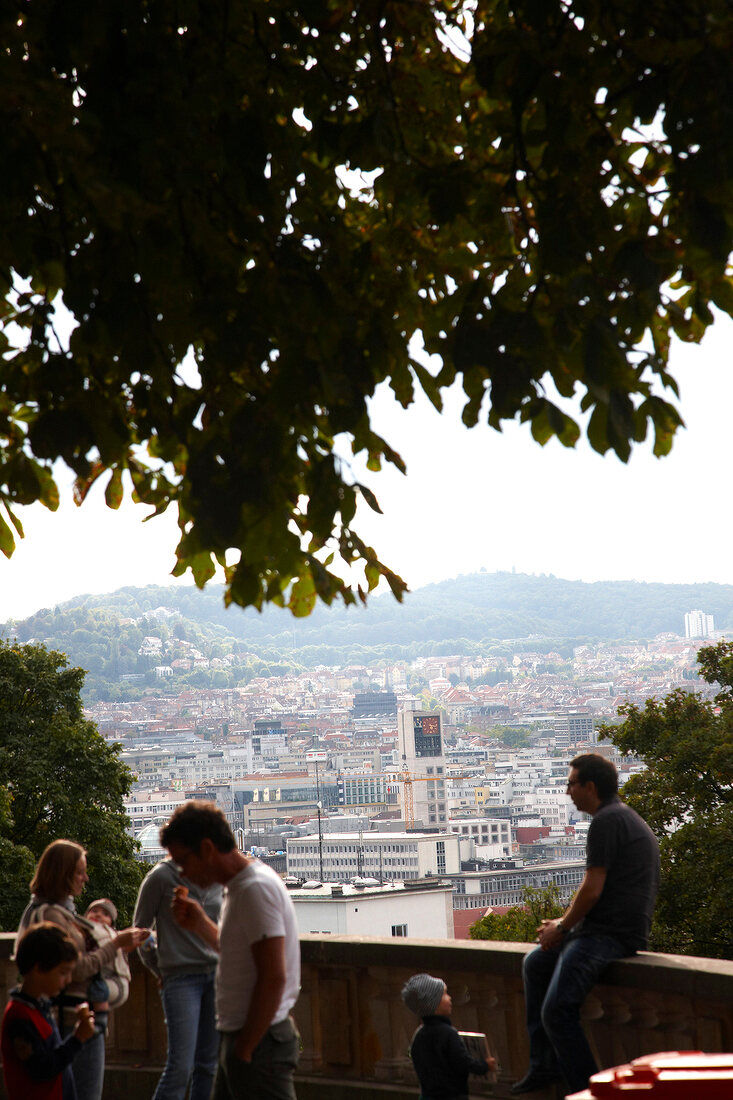 View of city of Stuttgart overlooking tourists standing on Eugensplatz, Germany