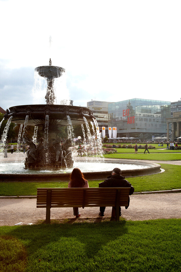 People sitting near springrunnen at Schlossplatz in Stuttgart, Baden-Wurttemberg, Germany