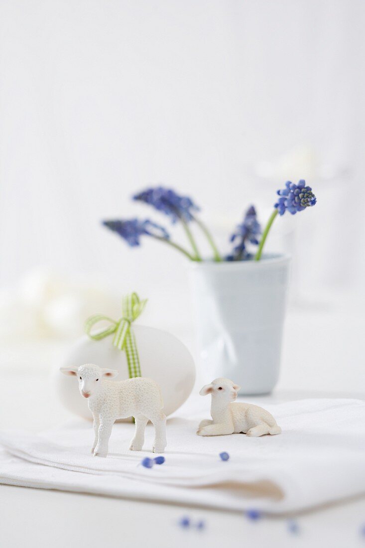 Decorative Easter lamb figurines, an egg and grape hyacinths