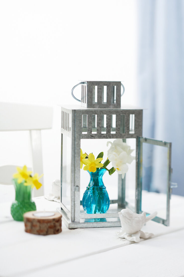 Grey garden lantern with blue vase