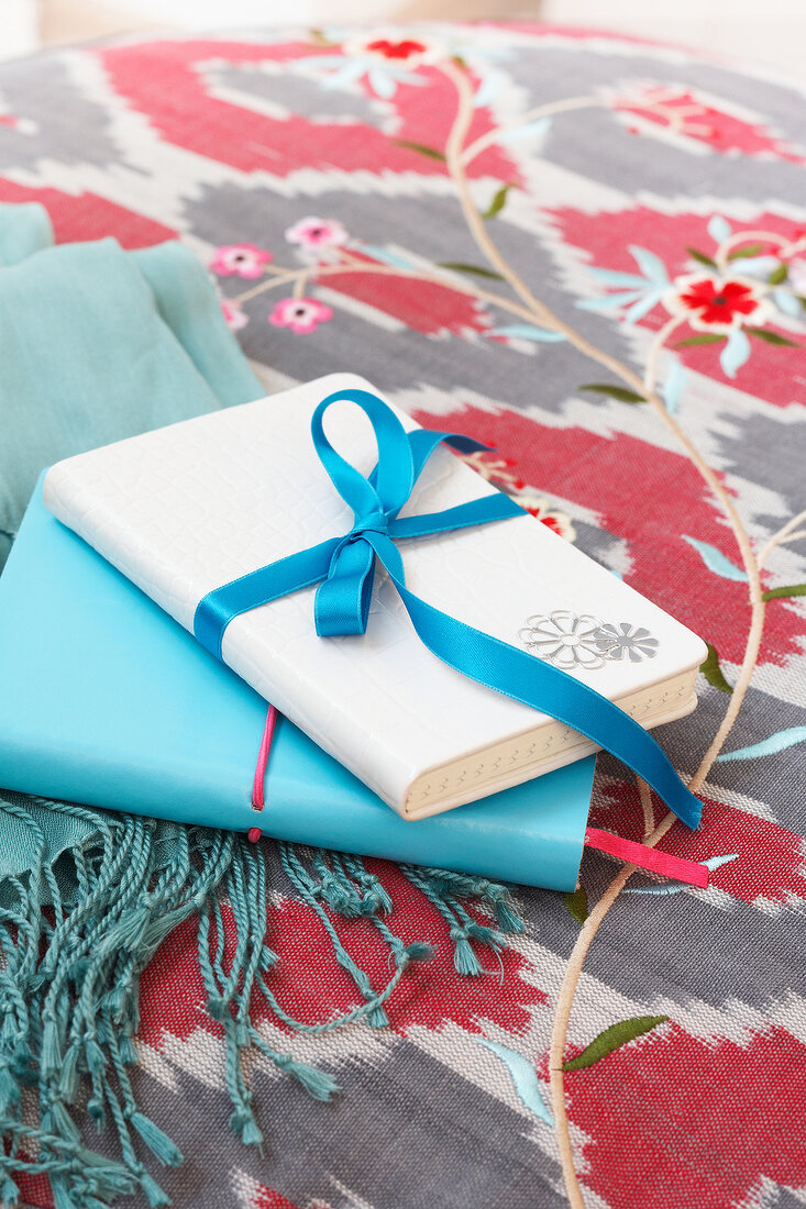 Blue and white notebook decorated with ribbons and sticker