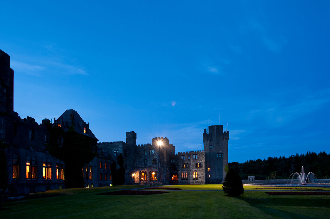 View of Ashford Castle and blue sky at dusk, Ireland, UK