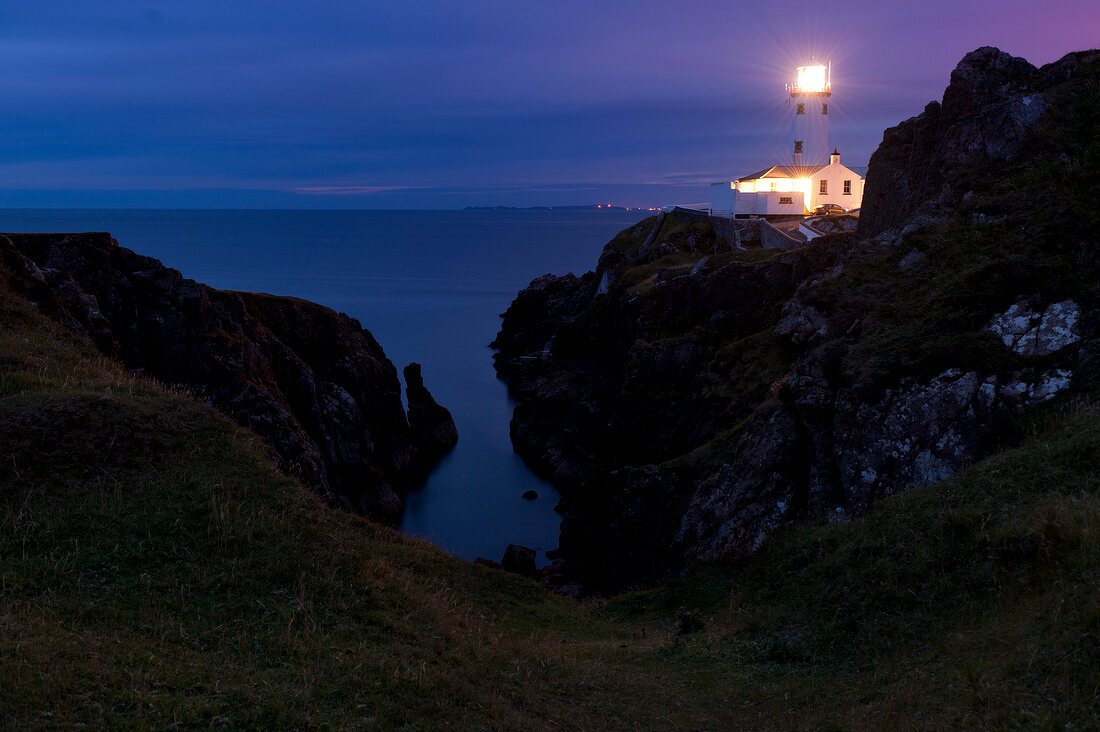 View of illuminated lighthouse at Fanad Head at night in County Donegal, Ireland, UK