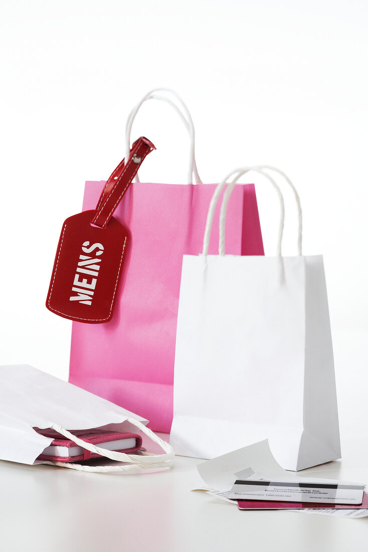 Close-up of paper shopping bags with notebooks