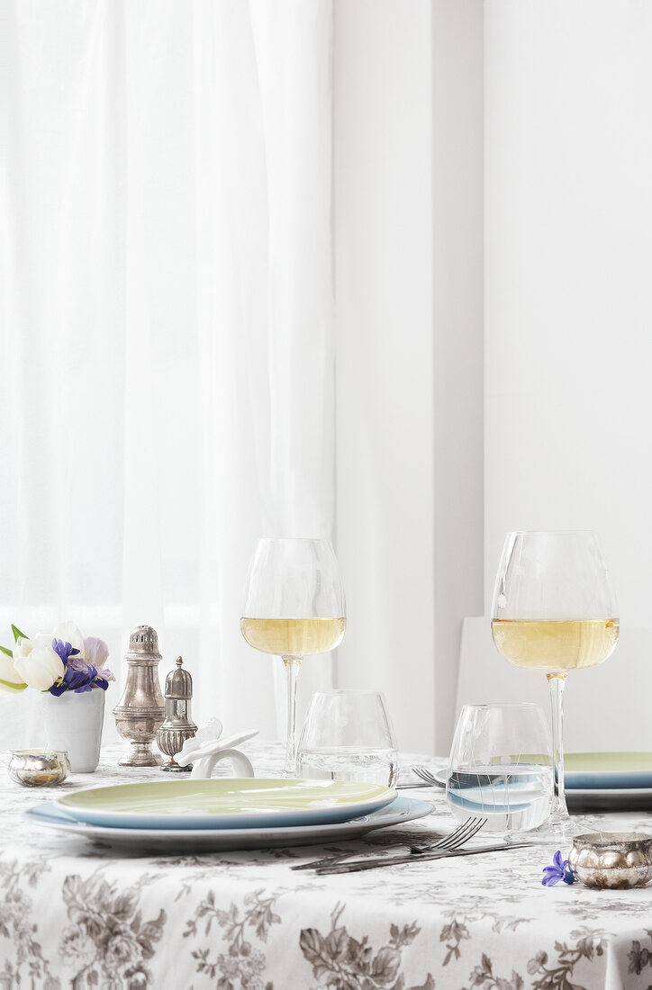 Vernal table decoration with white wine glasses and tableware