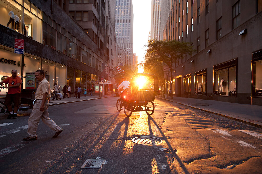 Horse carriage on street with people at sunset in New York, USA