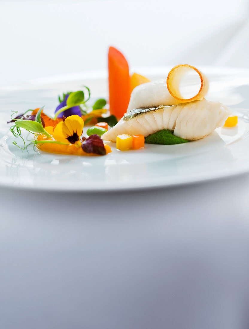 Close-up of carrot, coriander, coconut and flowers on plate