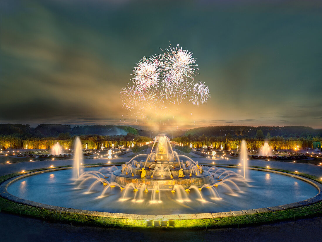 View of Illuminated Latona Fountain at dusk in Versailles, France