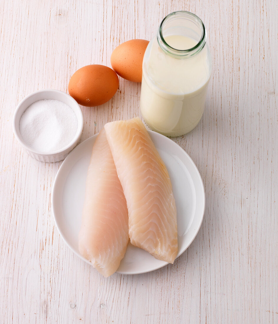 Fish, salt, eggs and milk on wooden surface - food rich in iodine