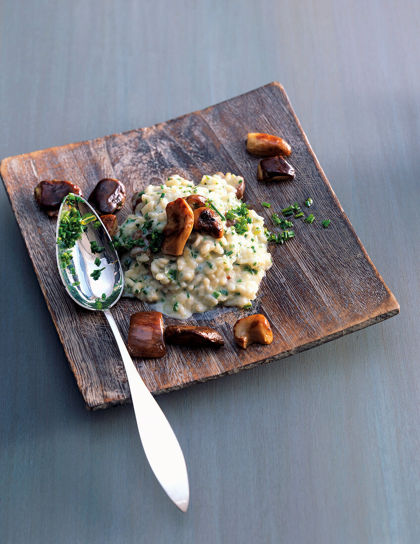 Porcini mushroom risotto on wooden tray