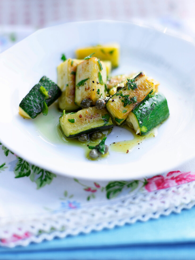 Marinated zucchini with capers on plate