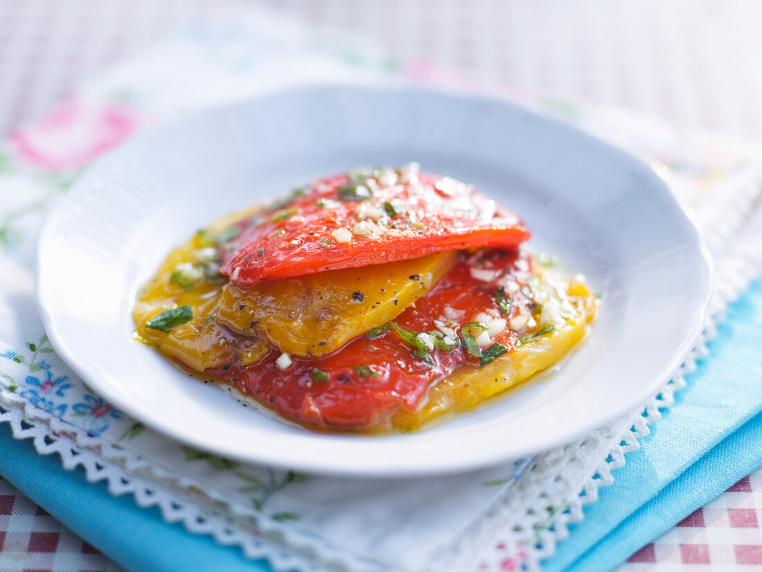Marinated peppers with marjoram on plate