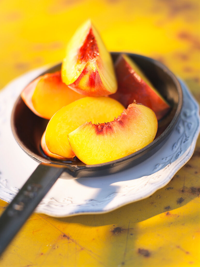 Close-up of slices of peach in pan