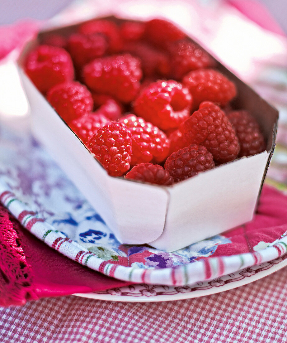 Close-up of bowl of raspberries in summer kitchen