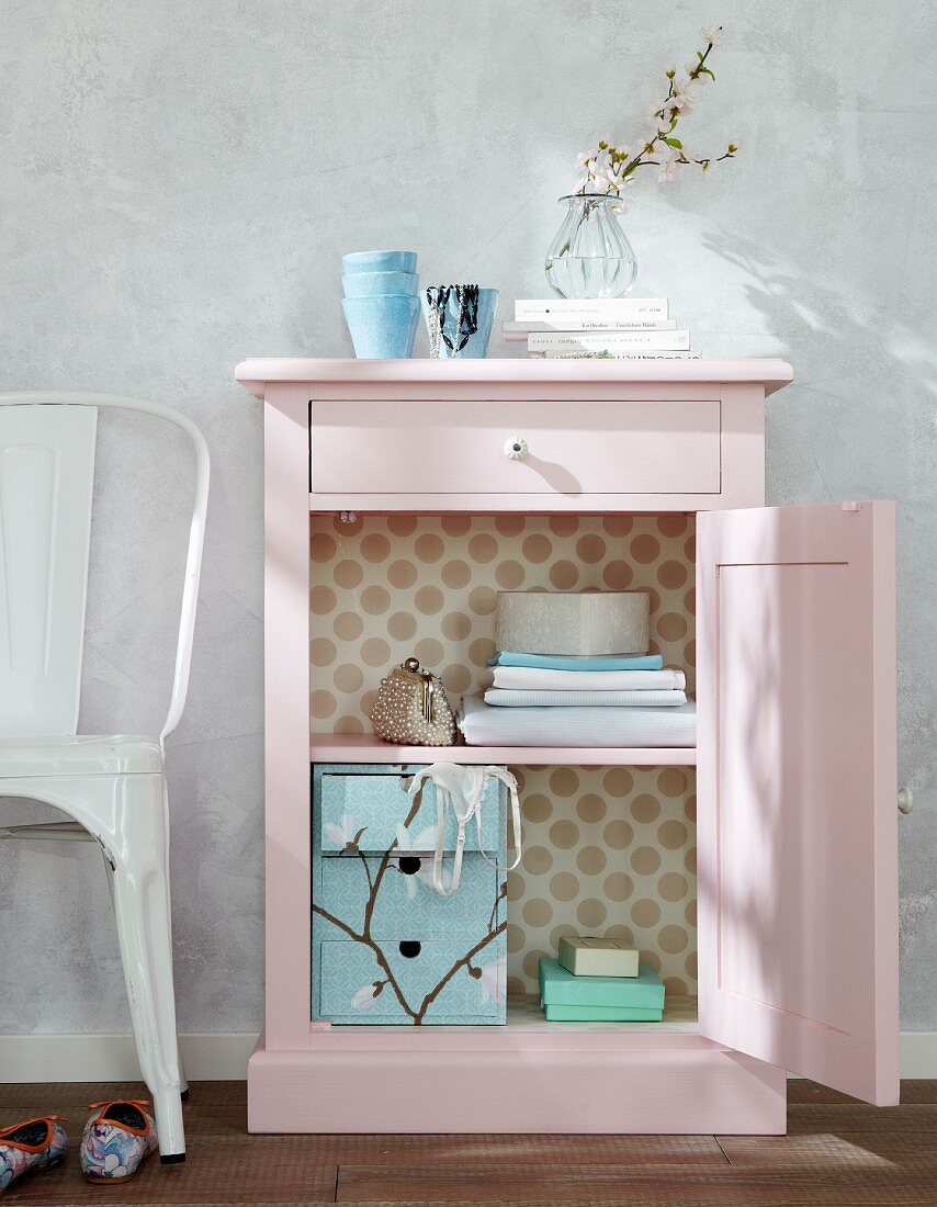 Small, pink cabinet with open door