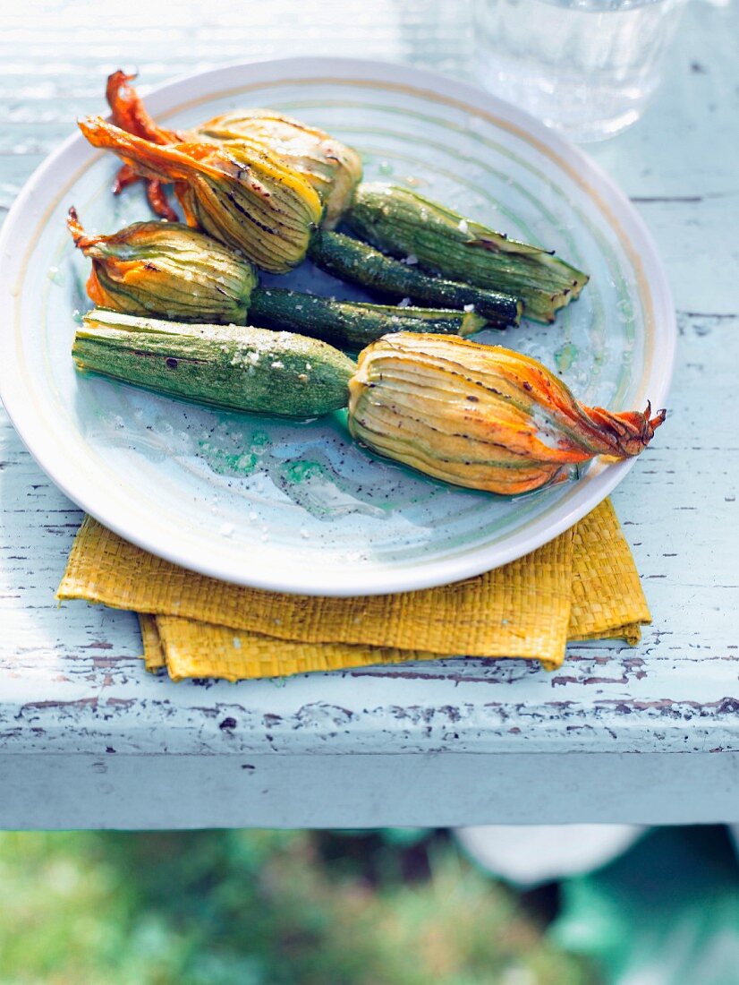 Stuffed courgette flowers on a table outside