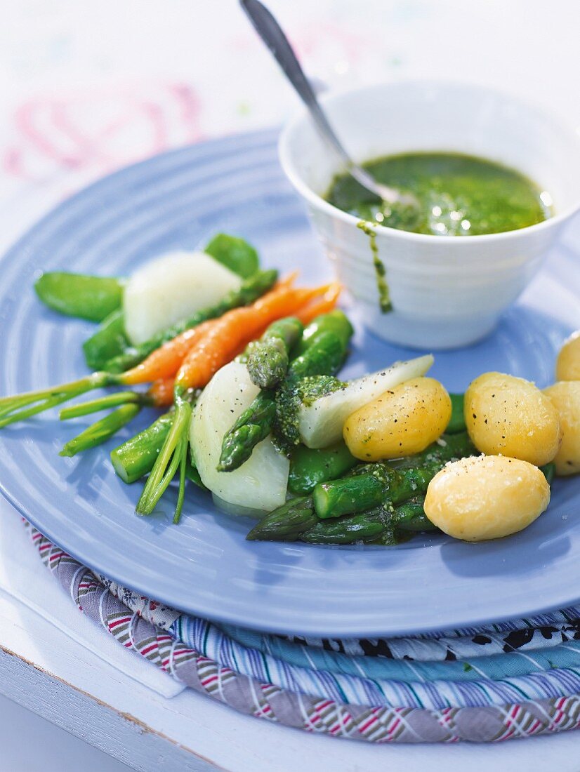 Colourful spring vegetables with pesto