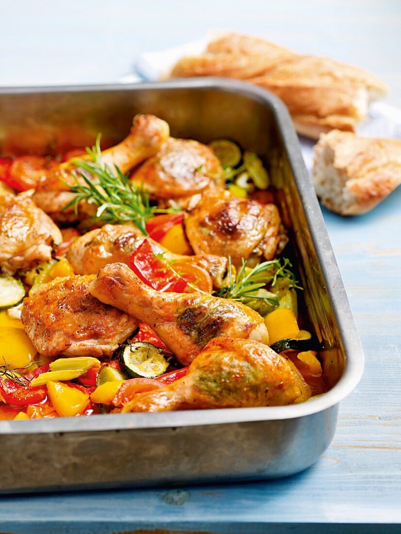 Chicken legs on a bed of oven-roasted vegetables