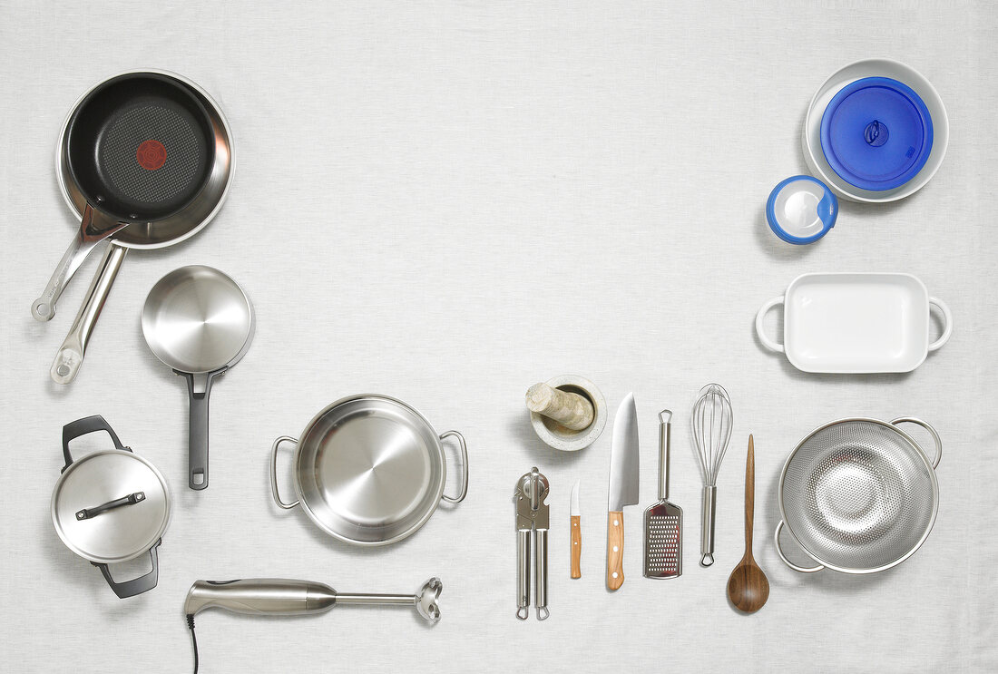 Various kitchen utensils on white background, overhead view