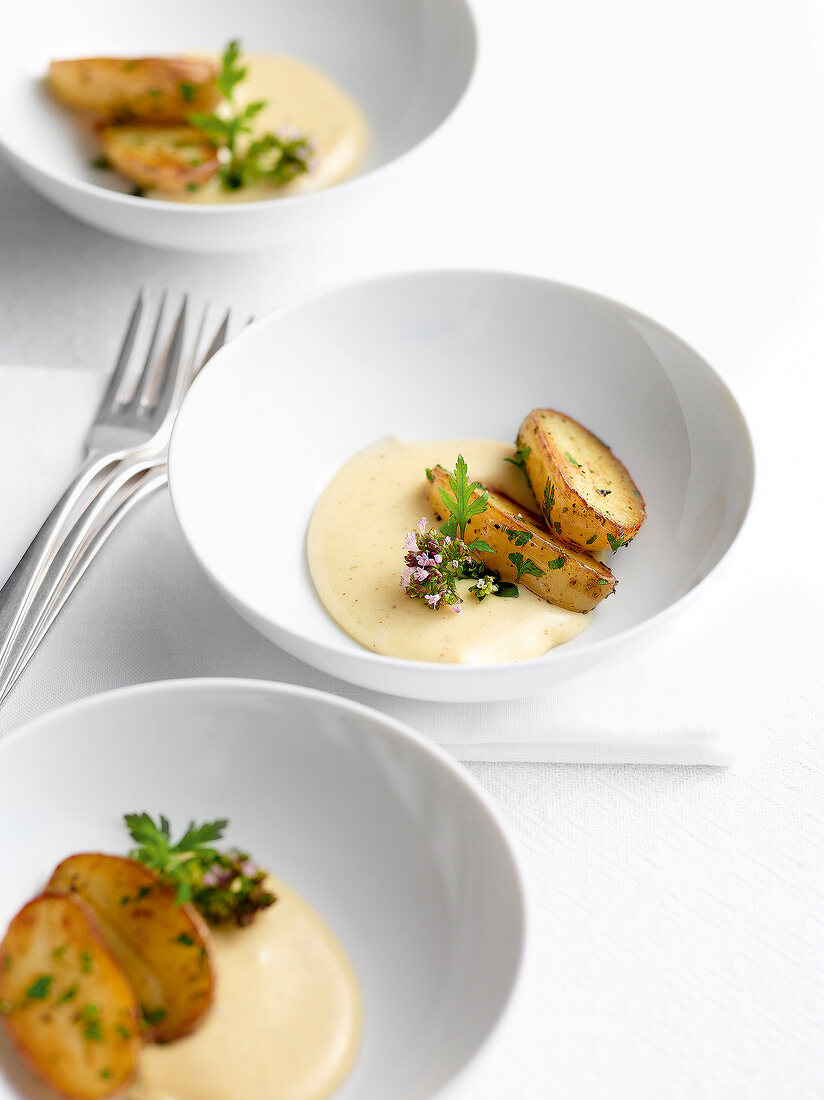 Classic melted Alpine cheese with small potatoes in bowls