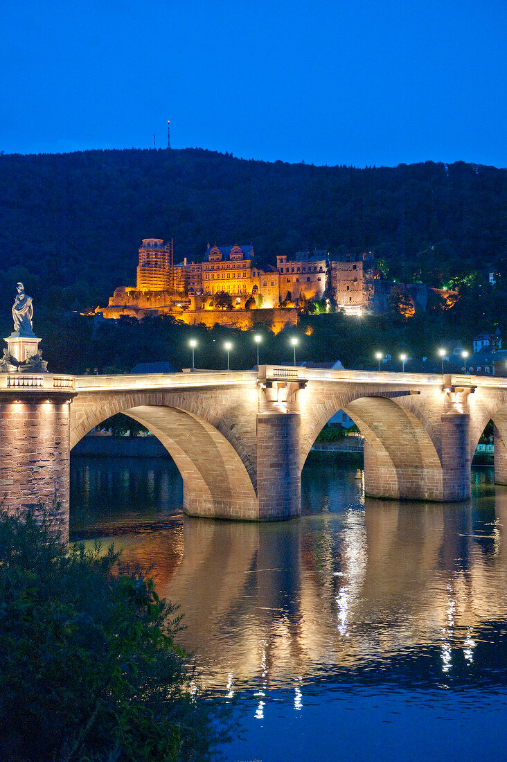 Illuminated Karl-Theodor-Bridge at evening in Heidelberg, Germany