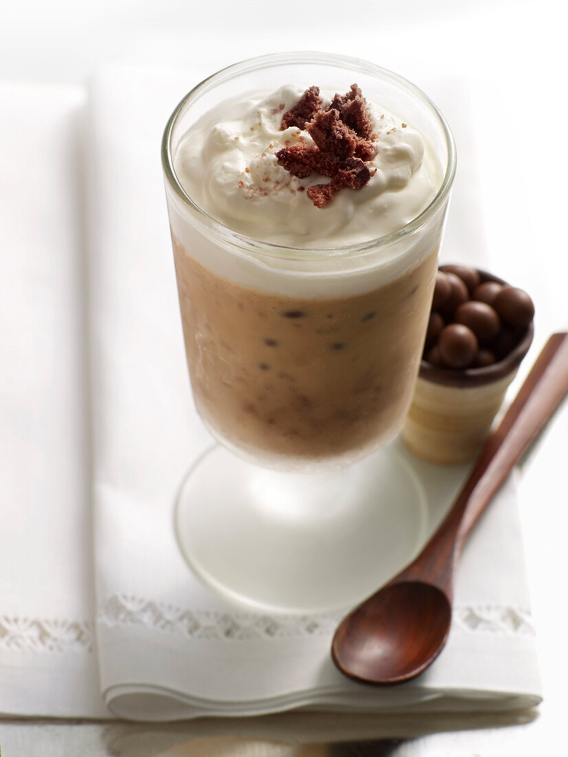 Glass of coffee tamped with coffee and ice-cream on tissue paper