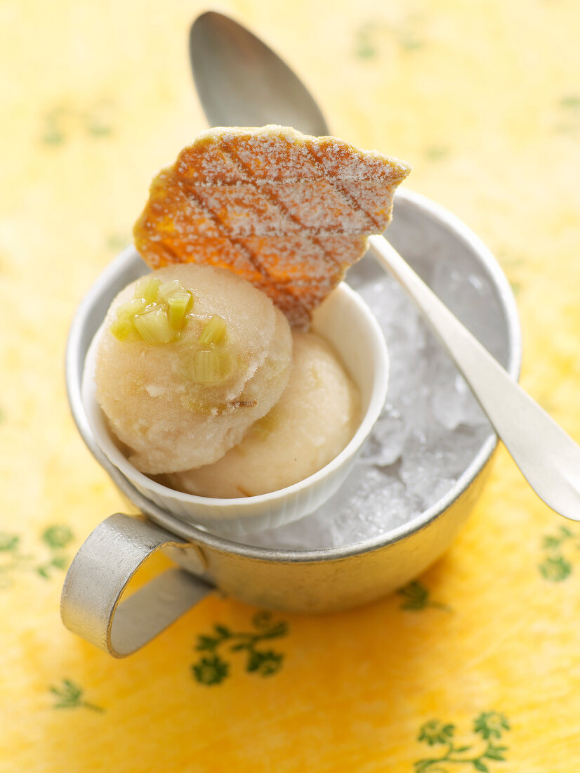 Elderflower sorbet with rhubarb and biscuit in cup filled with ice