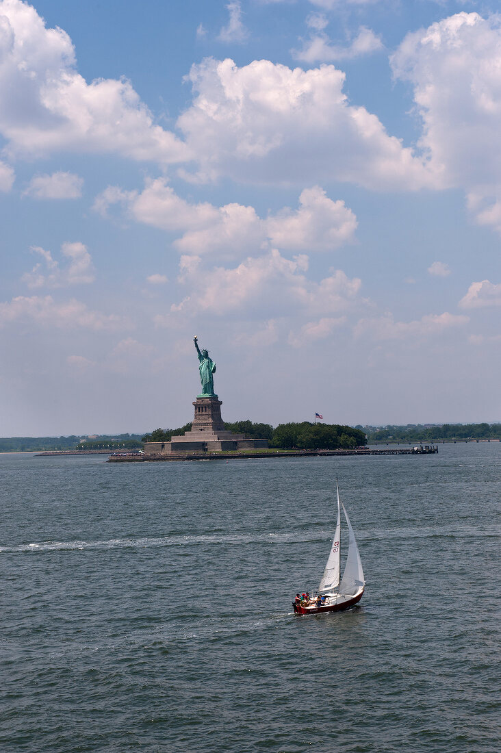 View of sailboat and Statue of Liberty, New York, USA