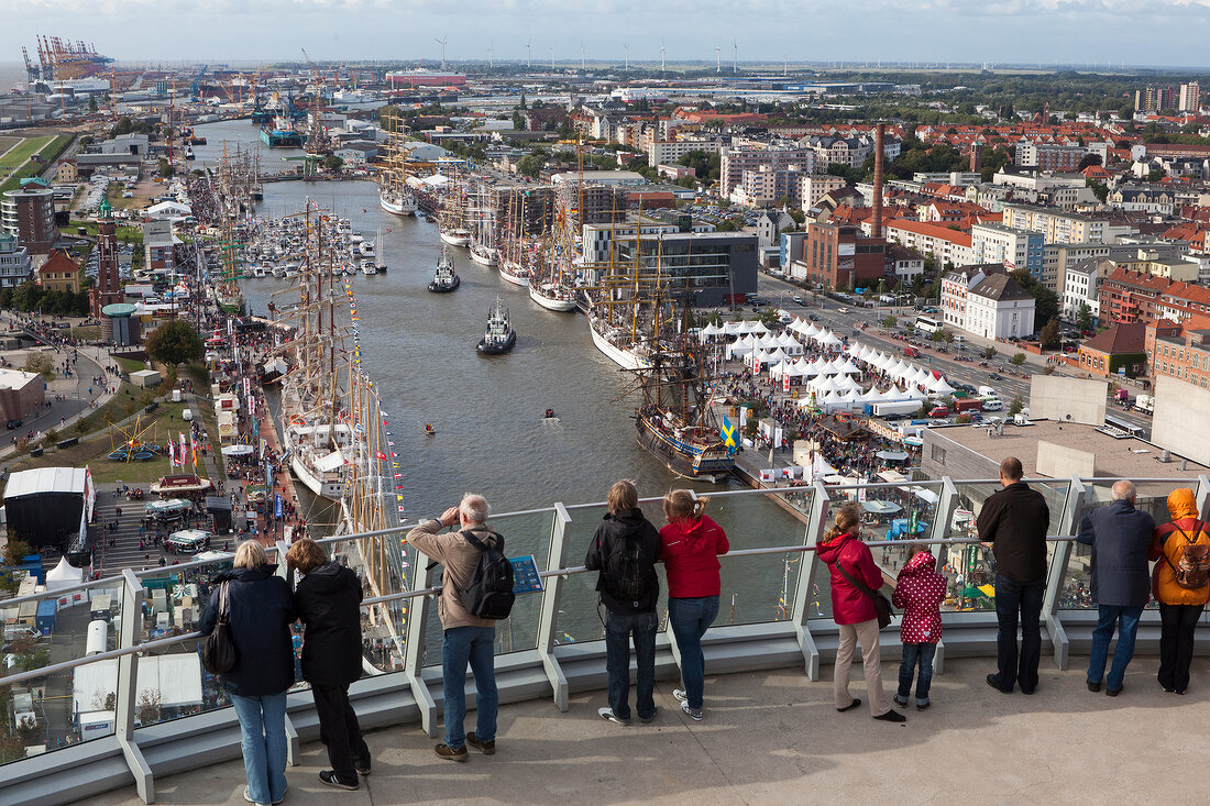 Tourists standing on Atlantic Sail City platform and looking at city, Bremerhaven, Germany