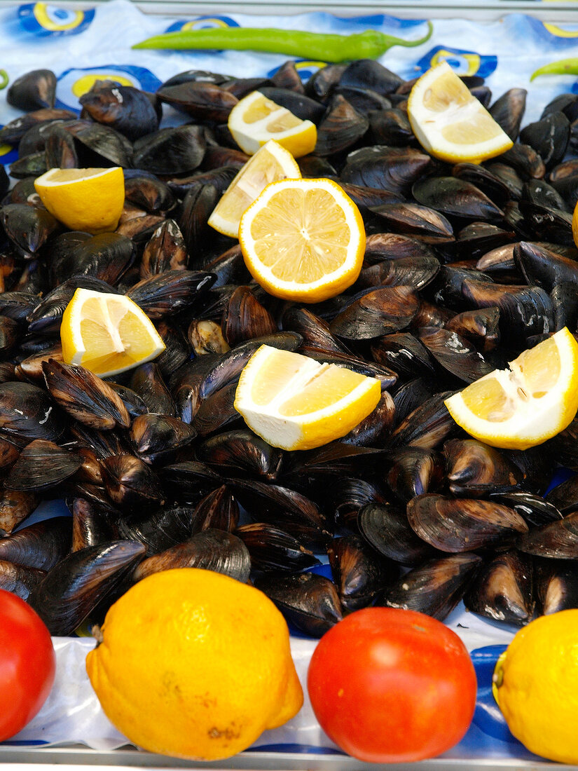 Close-up of fresh mussels and lemon wedges