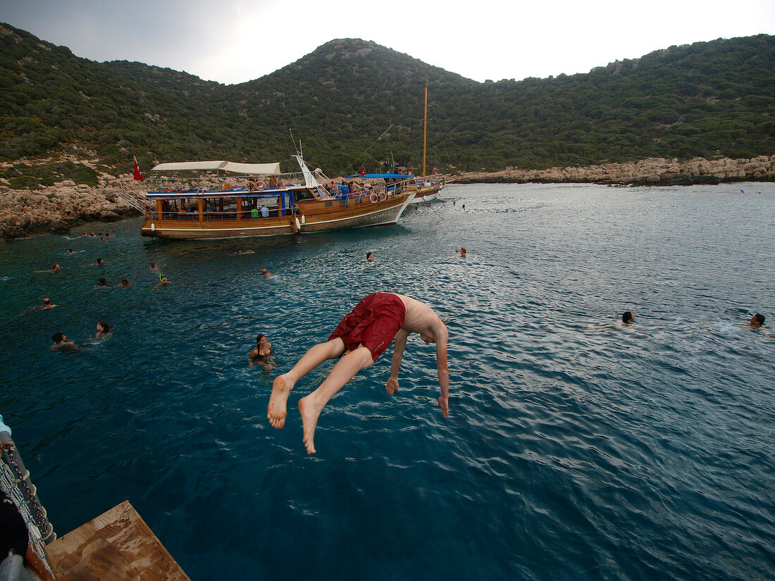 Man jumping into water in Kas, Lycia, Antalya, Turkey