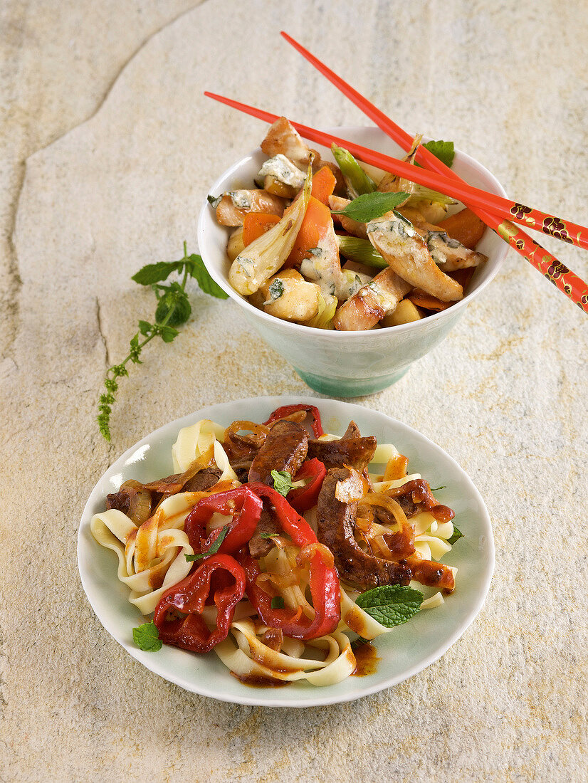 Pepper noodles with mint and stir-fried vegetables on plate